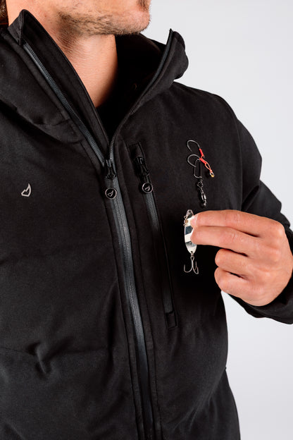 Person wearing a black jacket holding fishing equipment against a white background
